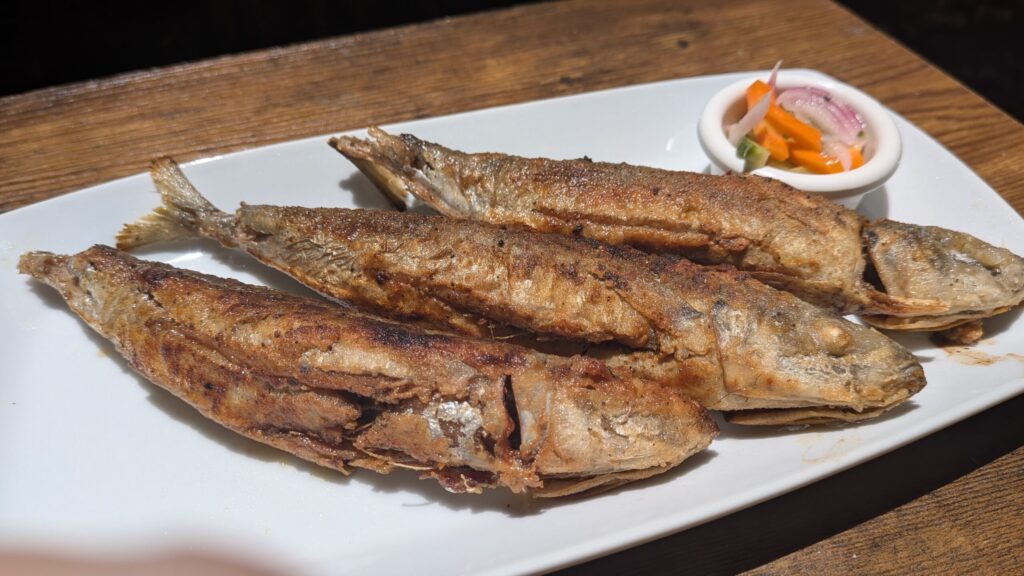 Grilled fish served with vegetables.